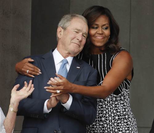 Michelle Obama hugs George W. Bush